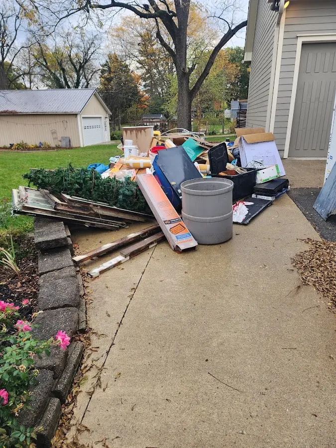 Dumpster being loaded with debris for Estate Cleanout Dumpster Rental in Woodbridge